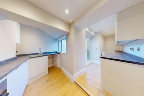 Bright and modern kitchen with sleek white cabi...