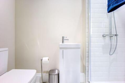 A modern and well-maintained bathroom suite fea...