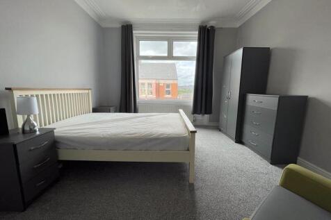 Bright double bedroom featuring a comfortable d...