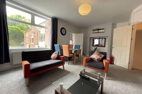 A bright and inviting living room featuring com...