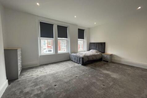 Spacious and bright master bedroom featuring th...