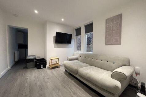A modern living room featuring a stylish beige ...