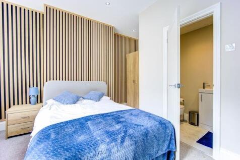 A bright and modern master bedroom featuring a ...