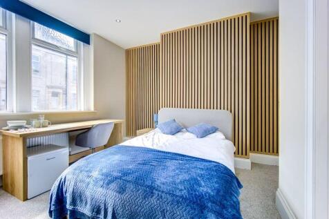 Bright and modern double bedroom featuring a co...