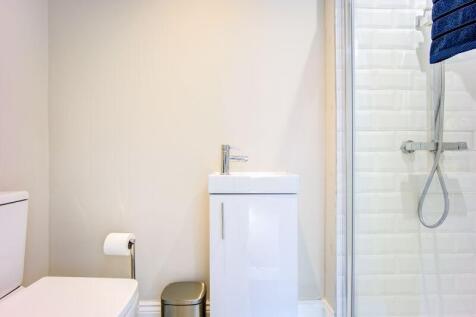 Bright and modern bathroom suite featuring a cl...