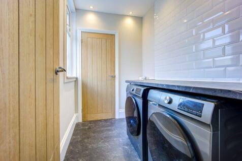 Bright and clean laundry room featuring modern ...