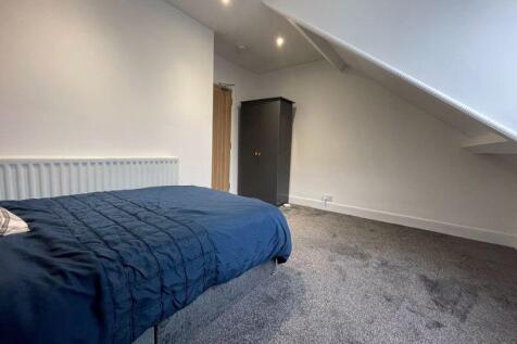 A neat and well-maintained bedroom featuring a ...