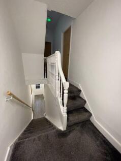 A clean and well-maintained staircase with neut...