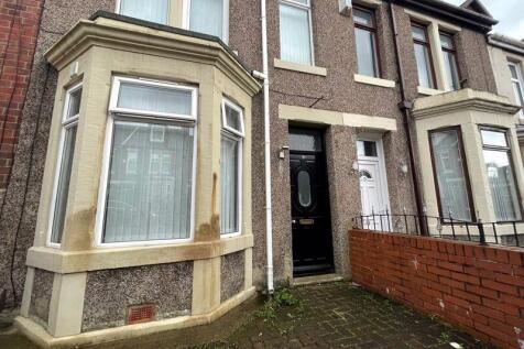 Charming terraced house exterior featuring a cl...