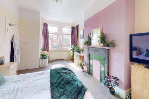 A bright and inviting master bedroom featuring ...