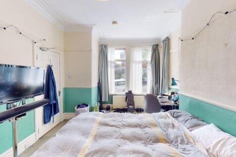 A spacious and bright master bedroom featuring ...