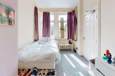 Bright and inviting bedroom with a large window...