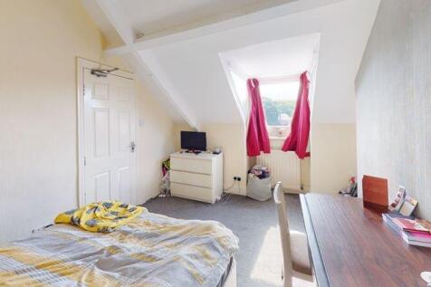 A small, clean room featuring a skylight with r...