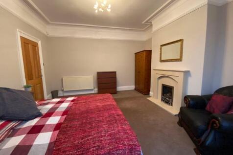 A spacious and inviting master bedroom featurin...