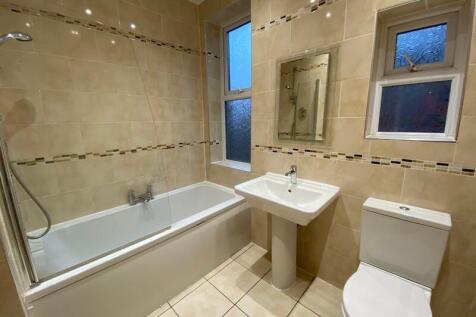 A clean and modern bathroom suite featuring a f...