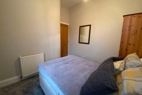 Bright and cozy double bedroom featuring a comf...