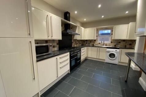 Bright and modern kitchen featuring sleek cream...