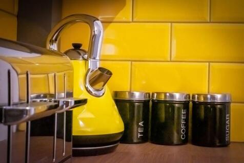 A vibrant kitchen corner featuring a bright yel...