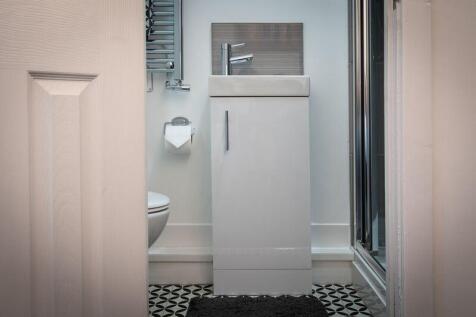 A modern bathroom featuring a sleek vanity unit...