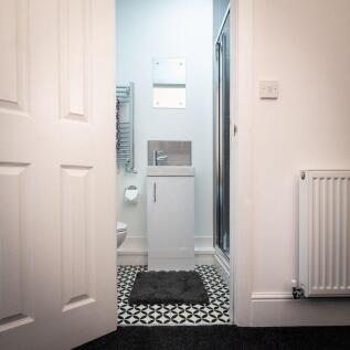 A modern bathroom featuring a sleek vanity unit...