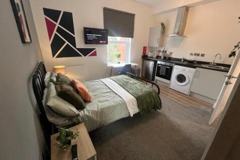 A cozy double bedroom with a comfortable bed, a...