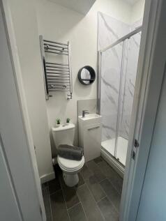 A modern bathroom featuring a sleek shower encl...