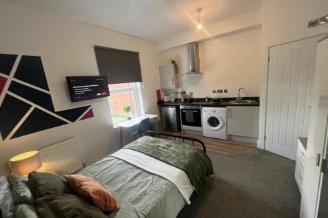 Cozy single bedroom featuring a comfortable bed...