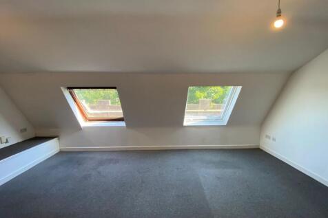 A clean and bright single bedroom featuring two...