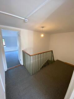 A clean and simple hallway area featuring neutr...