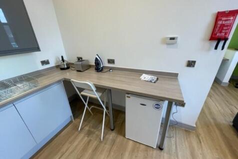 Bright and clean kitchenette featuring a sleek ...