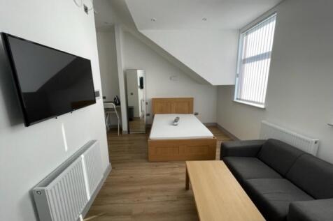 Bright and modern master bedroom featuring a co...