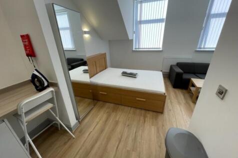 A bright and tidy double bedroom featuring a wo...