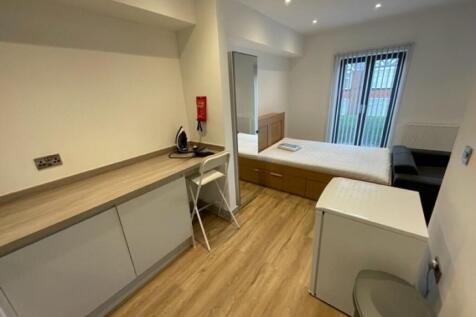 Bright and tidy bedroom featuring a comfortable...