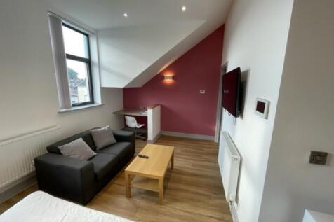 A modern master bedroom featuring a comfortable...