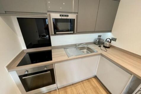 Modern kitchen with sleek cabinetry, integrated...