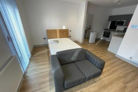 Bright and modern single bedroom featuring a co...