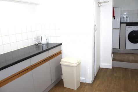 Bright kitchen area featuring modern grey cabin...