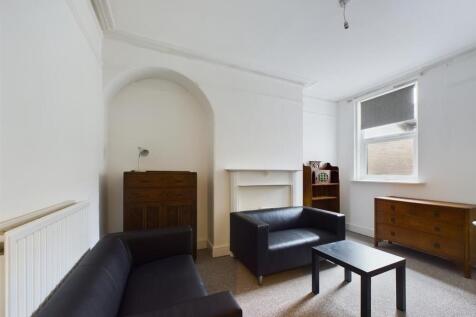 A cozy living room featuring two black leather ...