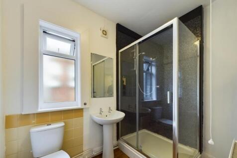 Bright and tidy bathroom featuring a spacious s...