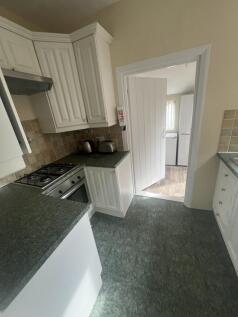 Bright kitchen featuring ample countertop space...
