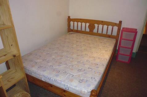 Cozy double bedroom featuring a sturdy wooden b...