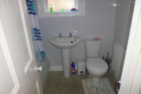 A clean and functional bathroom featuring a whi...