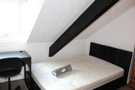 A bright and cozy double bedroom featuring a co...