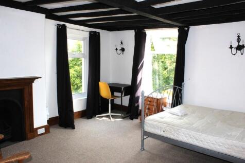 Bright and airy double bedroom featuring two la...