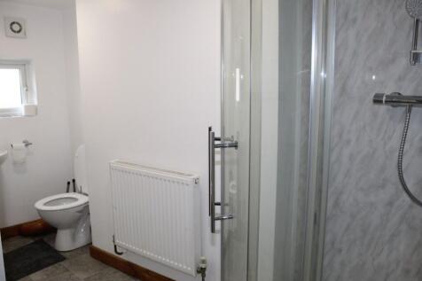 Bright and clean bathroom featuring a modern sh...