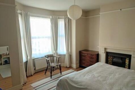 A bright and spacious master bedroom featuring ...