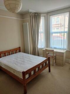 A bright and tidy double bedroom featuring a wo...