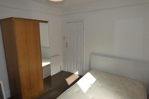 Bright double bedroom featuring a comfortable b...