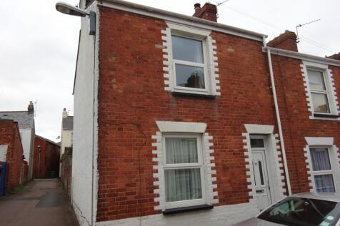 Charming red brick end-terrace house with white...