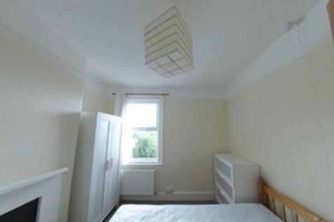 A bright double bedroom featuring a large windo...